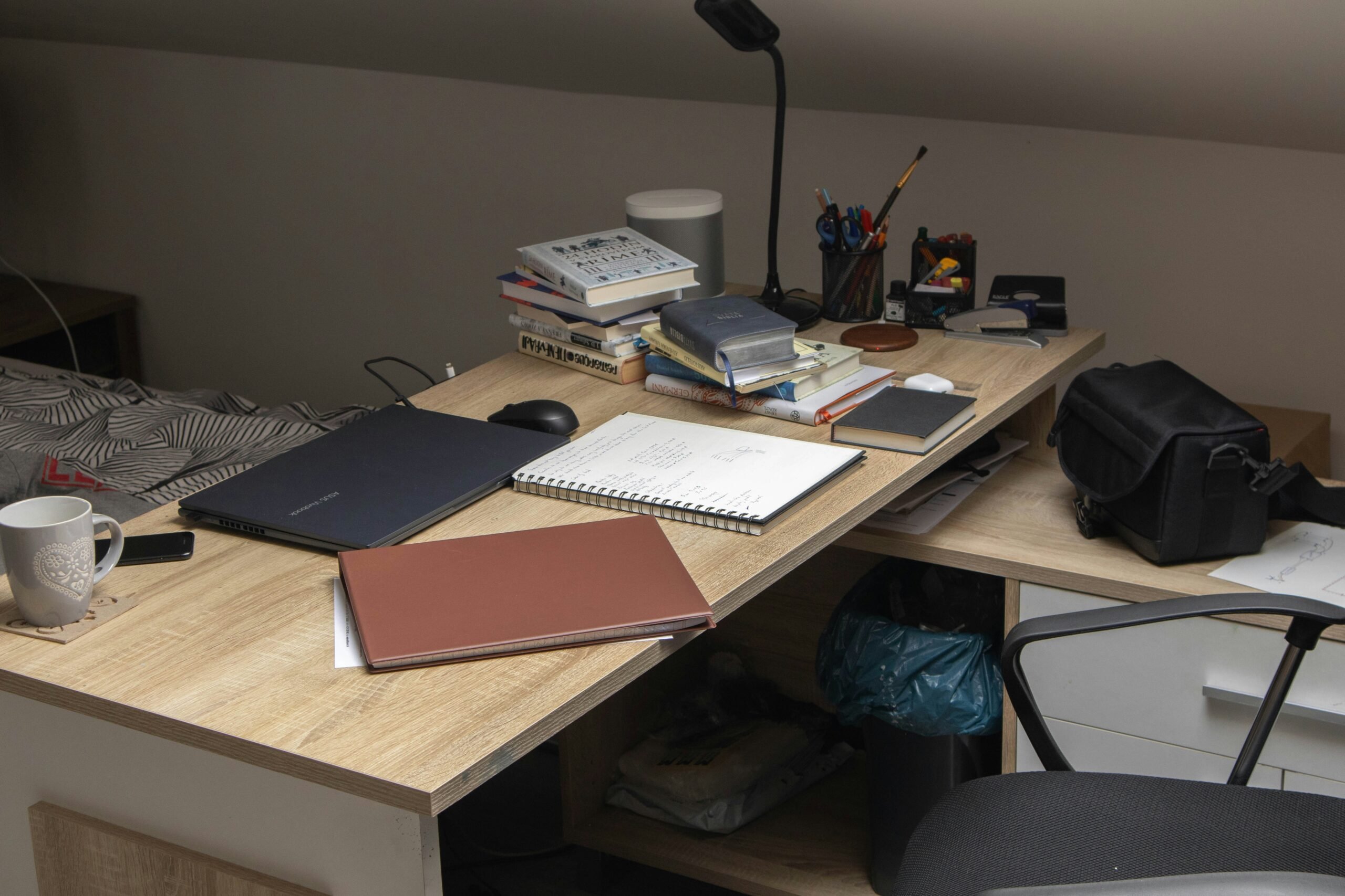 A chaotic desk covered with papers and devices symbolizing disorganized finances