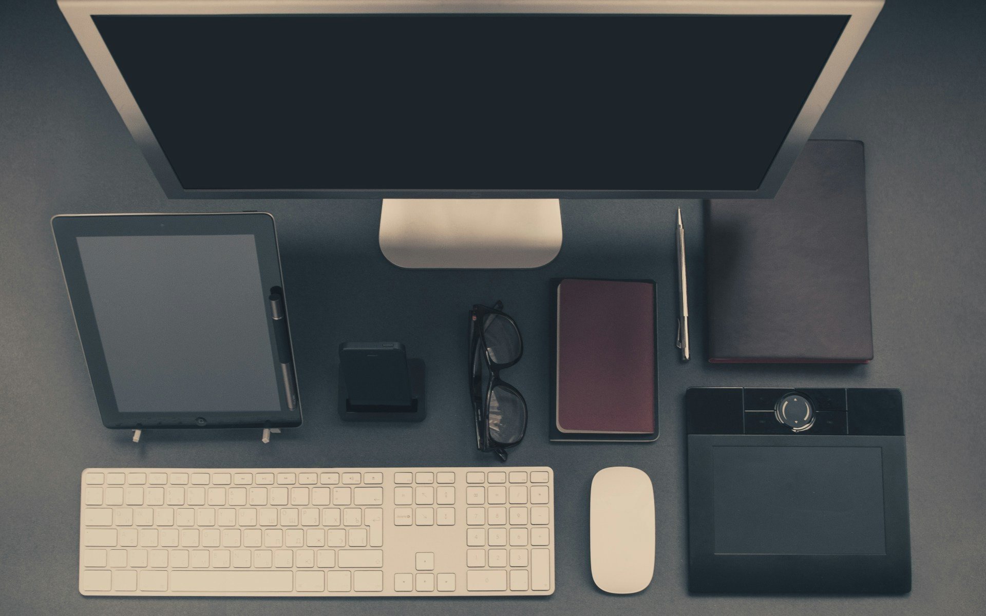 A cluttered desk with papers and spreadsheets representing manual budgeting struggles