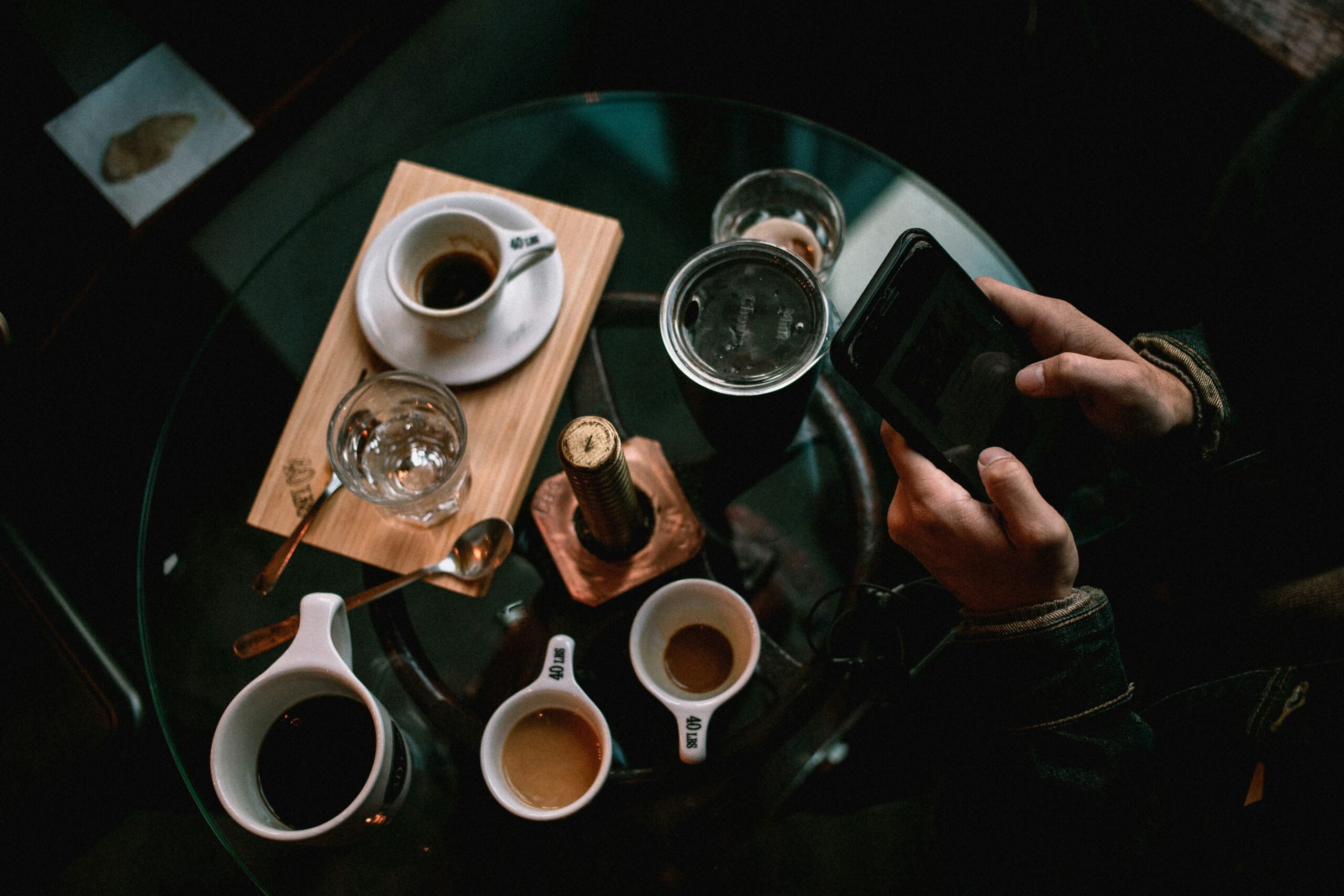 A stressed marketer surrounded by spreadsheets and coffee cups